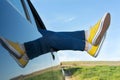 Woman legs out of the car window Royalty Free Stock Photo