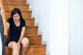 Woman legs pain with touching her knee and walking up stairs at home