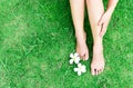 Woman legs relax feeling on green grass background with light of Royalty Free Stock Photo