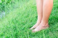 Woman legs relax feeling on green grass background with light of Royalty Free Stock Photo