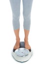 Woman, legs and scale in studio for weight loss, healthcare and wellness for vitality. Female person, diet and check Royalty Free Stock Photo