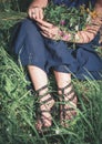 Woman legs sitting in grass on summer meadow Royalty Free Stock Photo