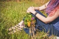 Woman legs sitting in grass on summer meadow Royalty Free Stock Photo