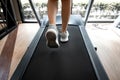 Woman legs with sport shoes running on treadmill in fitness gym