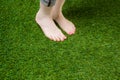 Woman legs standing on green grass Royalty Free Stock Photo