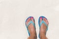 Woman legs stands in sea water on a tropic beach Royalty Free Stock Photo