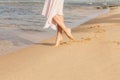 Woman legs walking on the beach sand Royalty Free Stock Photo