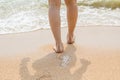 Woman legs walking on the beach sand Royalty Free Stock Photo