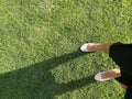 Woman legs is walking on grass floor Royalty Free Stock Photo