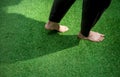 Woman legs walking on green grass Royalty Free Stock Photo