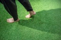 Woman legs walking on green grass Royalty Free Stock Photo