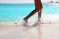 Woman legs walking splashing beach aqua water Royalty Free Stock Photo