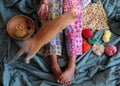 Woman legs with warm in wintertime, crocheted colorful blanket by link many pieces artwork Royalty Free Stock Photo