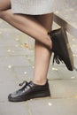 Woman legs wearing black shoes on the street Royalty Free Stock Photo