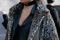 Woman with leopard fur coat and black leather jacket before Giorgio Armani fashion show, Milan Fashion Week