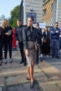 Woman with leopard skin skirt and black shirt before Tods fashion show, Milan Fashion Week