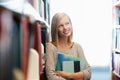 Woman, library and book, thinking about story for education and knowledge with smile on campus. College student with Royalty Free Stock Photo