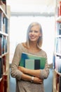 Woman, library and books, portrait for education and knowledge with smile on campus. College student, bookstore and Royalty Free Stock Photo