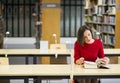 Woman in library seek knowledge from book