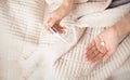 A woman lies in bed with a blanket and feels sick, holds a pills and thermometer in detail Royalty Free Stock Photo