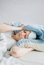 woman lies in bed and yawns or sleeps with a sleeping mask on her face. a European woman with sleep problems and