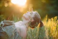 Woman lies and enjoys among wildflowers at sunset Royalty Free Stock Photo