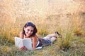 Woman lies on grass and reads book Royalty Free Stock Photo