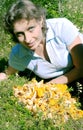 A woman lies on a lawn near the chanterelle Royalty Free Stock Photo