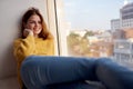 woman lies near the window dreamy look Royalty Free Stock Photo