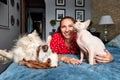 A woman lies on a sofa with a cat and a dog. Love for pets concept Royalty Free Stock Photo