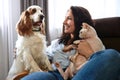 A woman lies on a sofa with a cat and a dog. Love for pets concept Royalty Free Stock Photo