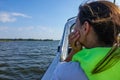 Woman with life jacket in a boat looking out over the ocean Royalty Free Stock Photo