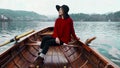 Pretty young girl sitting in boat and looking for the inspiration at background of the Alph mountain view. Happy asian