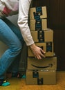 Woman lifting heavy Amazon Prime boxes during Prime Day offer sa