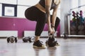 Woman lifting Kettle bell while crouching in gym Royalty Free Stock Photo