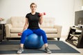 Woman lifting weights at home Royalty Free Stock Photo