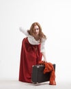 Woman lifts a heavy suitcase