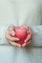 A woman in a light warm wool holds a candle in her hands, copies space, selects focus. The concept of Christmas, New Year Royalty Free Stock Photo