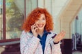 Woman in light white floral jacket talking at her cellphone Royalty Free Stock Photo