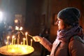 Woman lighting candle in church Royalty Free Stock Photo