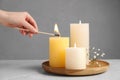 Woman lighting candle at light table, closeup Royalty Free Stock Photo