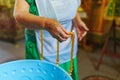 Woman lighting candles on a Baptismal font in the Orthodox Church. Royalty Free Stock Photo