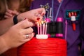Woman lighting candles on a birthday cake Royalty Free Stock Photo