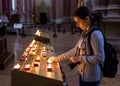 Woman lighting candles in church Royalty Free Stock Photo