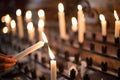 Woman lighting prayer candle Royalty Free Stock Photo