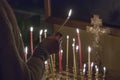 Woman lighting prayer candle Royalty Free Stock Photo