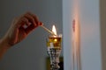 A woman lights Shabbat candles