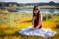 Woman like a fairy on the magic field near the river. Young woman with dandelion. Fantasy style