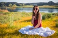 Woman like a fairy on the magic field near the river. Young woman with dandelion. Fantasy style