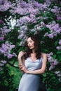 Woman in lilac blooming garden, luxury fashion model. Outdoor Royalty Free Stock Photo